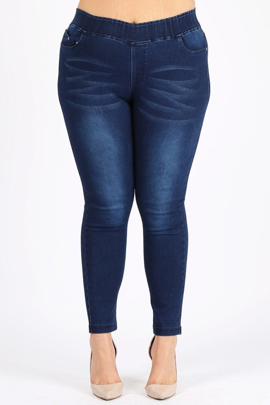 A pair of navy blue jeggings with a high waist and slim fit, displayed on a model without showing the upper part of the body.