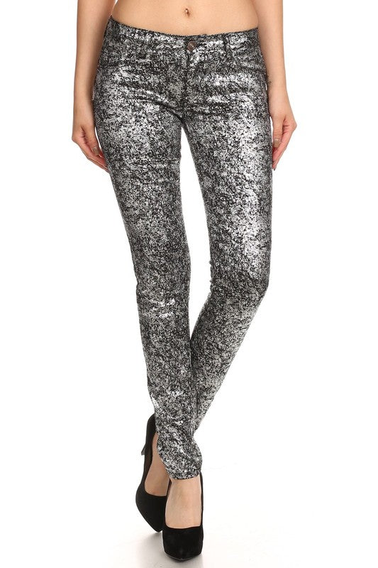 A pair of skinny jeans with a shimmer-sheen finish, displayed on a model without a top.