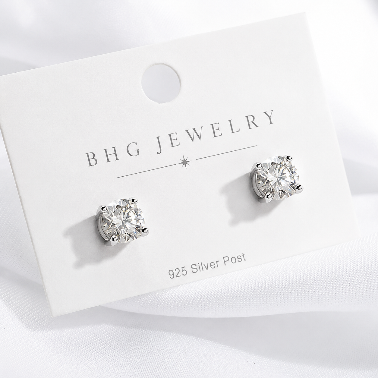 Silver stud earrings on a BHG Jewelry card with a white background