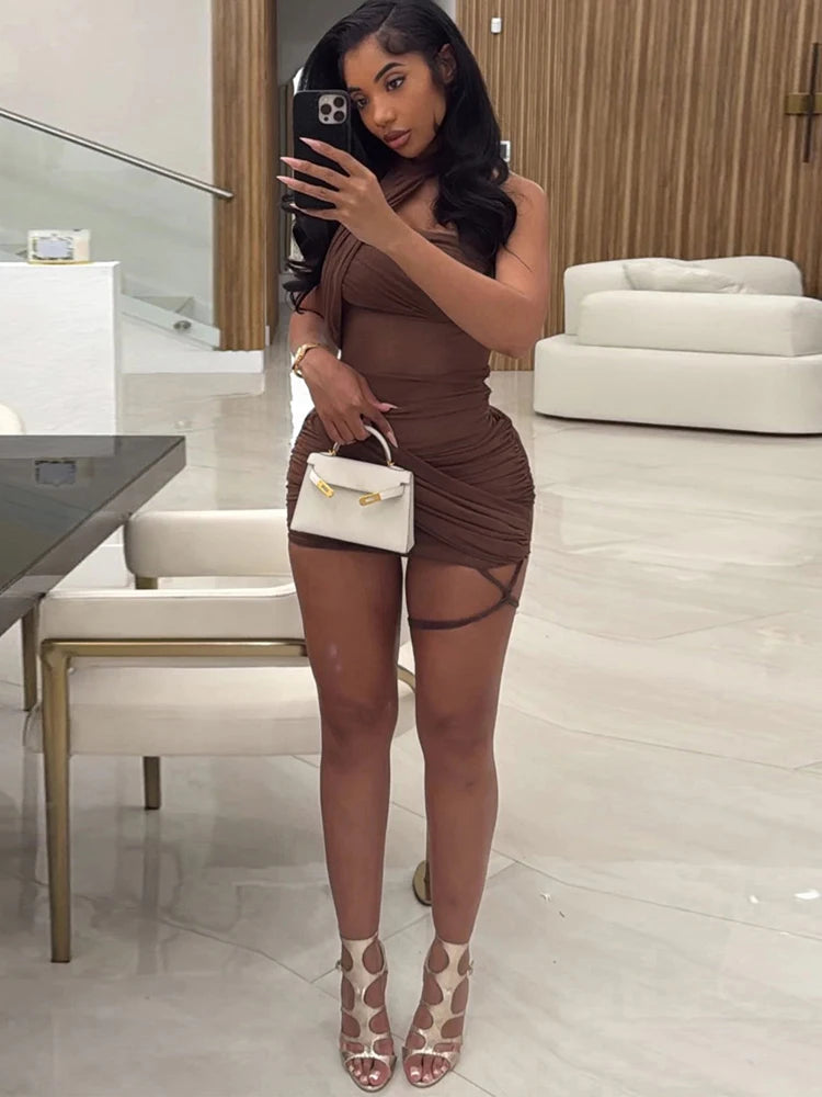 Woman taking a mirror selfie in a stylish outfit in a modern interior setting