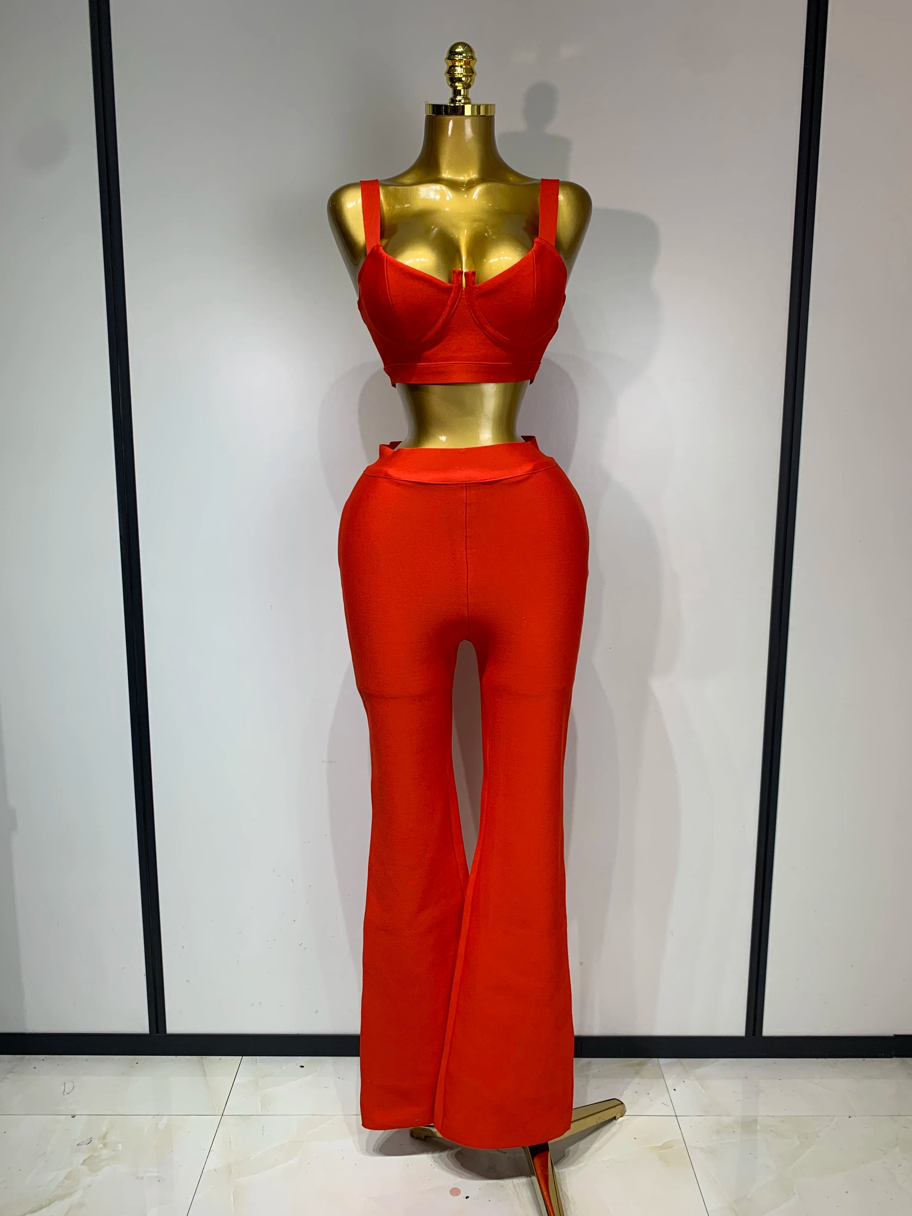 Mannequin wearing a red outfit against a plain background