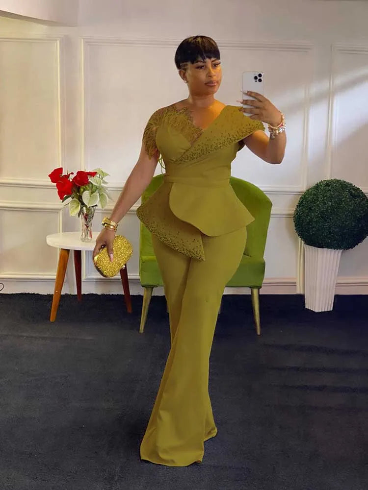 Woman in a yellow outfit taking a mirror selfie in an indoor setting.