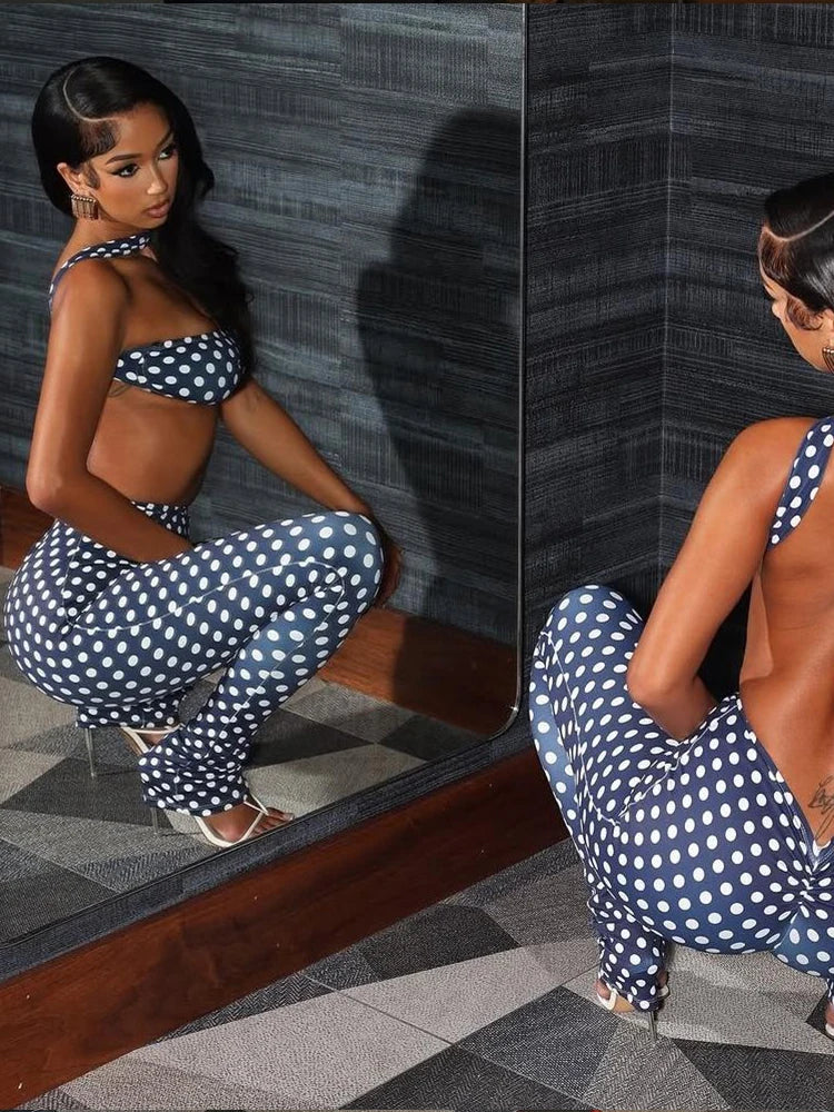 Woman in a polka dot outfit posing in front of a mirror.