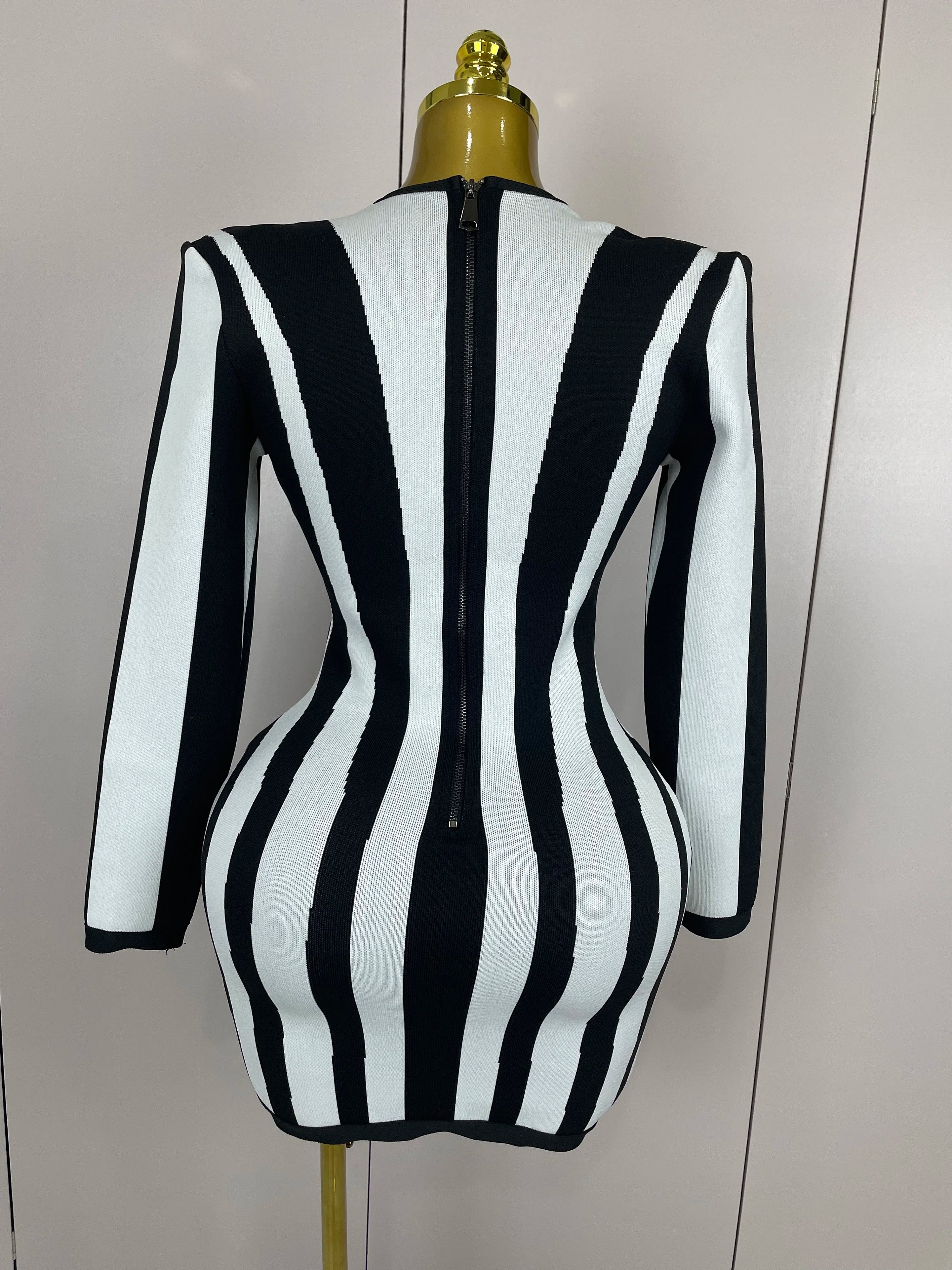 Black and white striped dress on a mannequin against a plain background