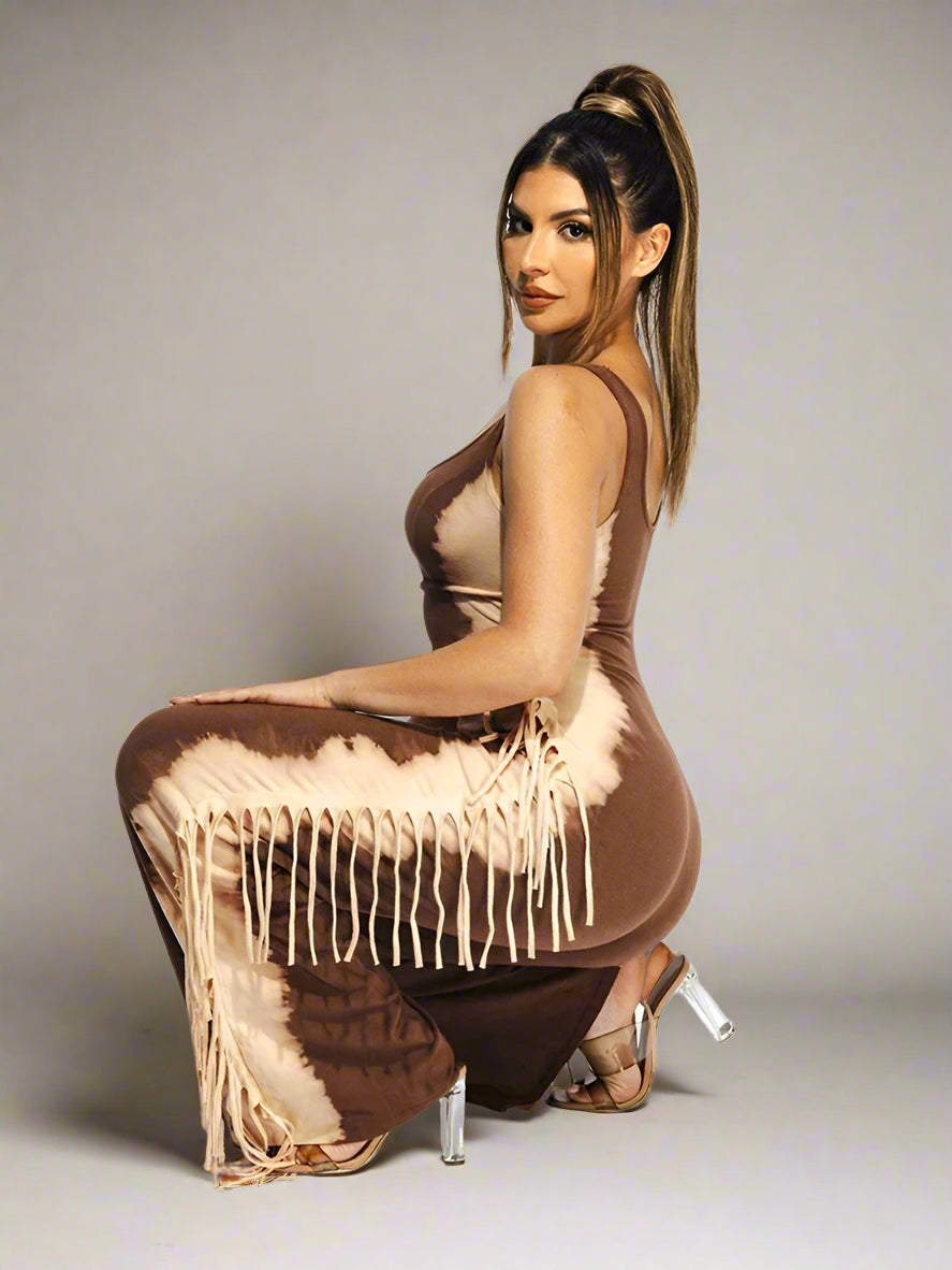 Woman wearing a brown dress with feather details on a white background