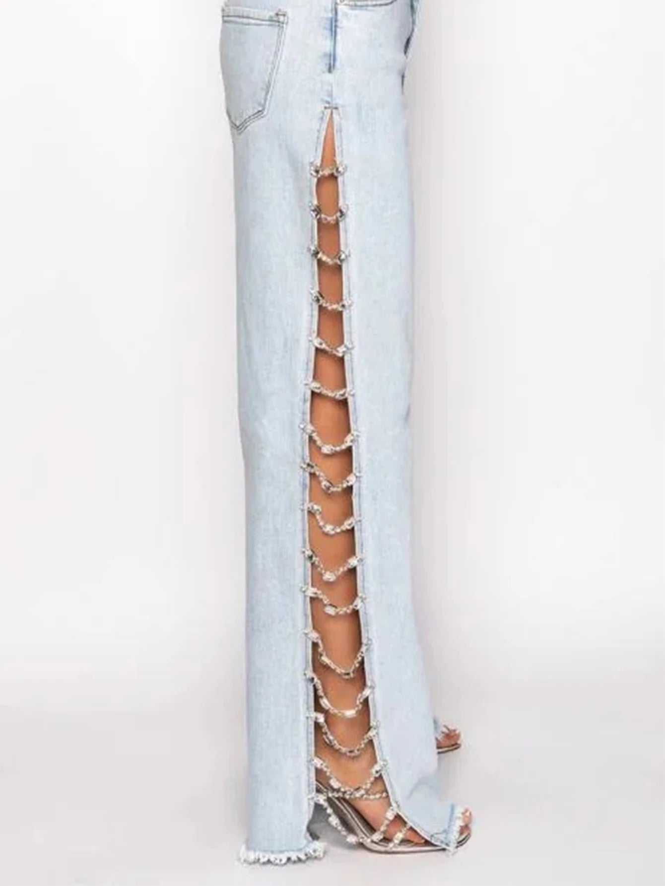 Light blue jeans with cut-out side design on a white background