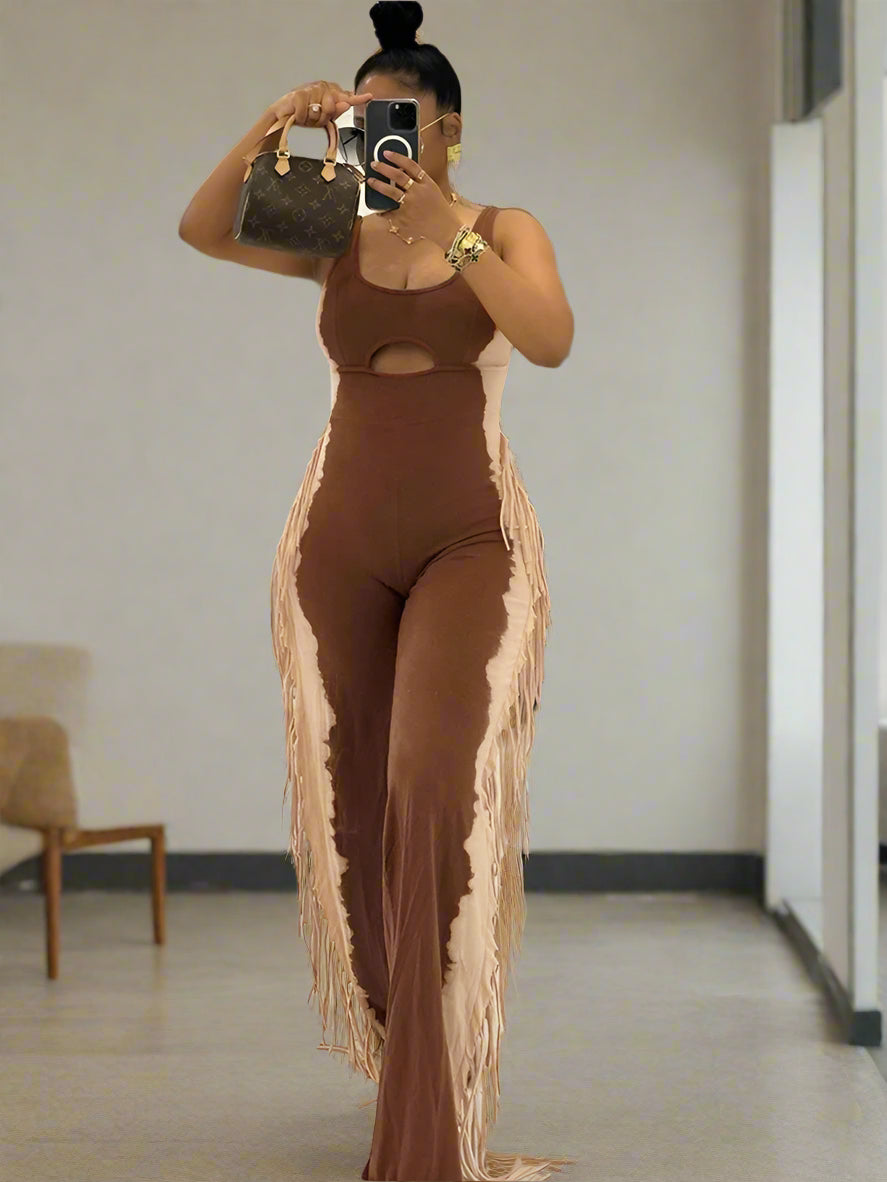 Person wearing a brown outfit with fringe details in an indoor setting