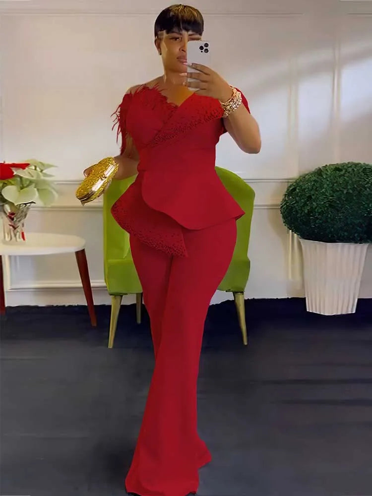 Person wearing a red outfit taking a mirror selfie in an indoor setting.